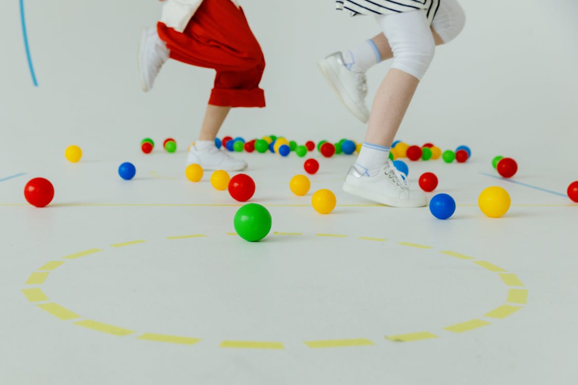 Free People Running on the Floor with Colorful Balls  Stock Photo