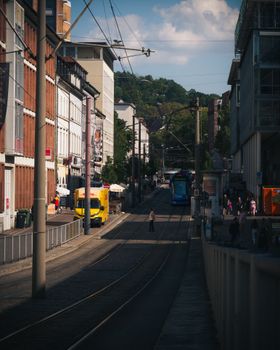 A vibrant urban street with tram and pedestrians in Freiburg, Germany capturing daily city life.