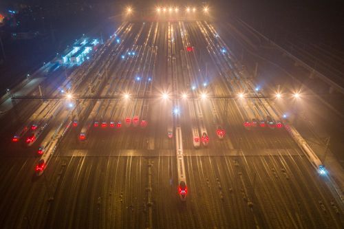 Free A nighttime aerial view of trains at an illuminated railway station in Nanjing, China. Stock Photo