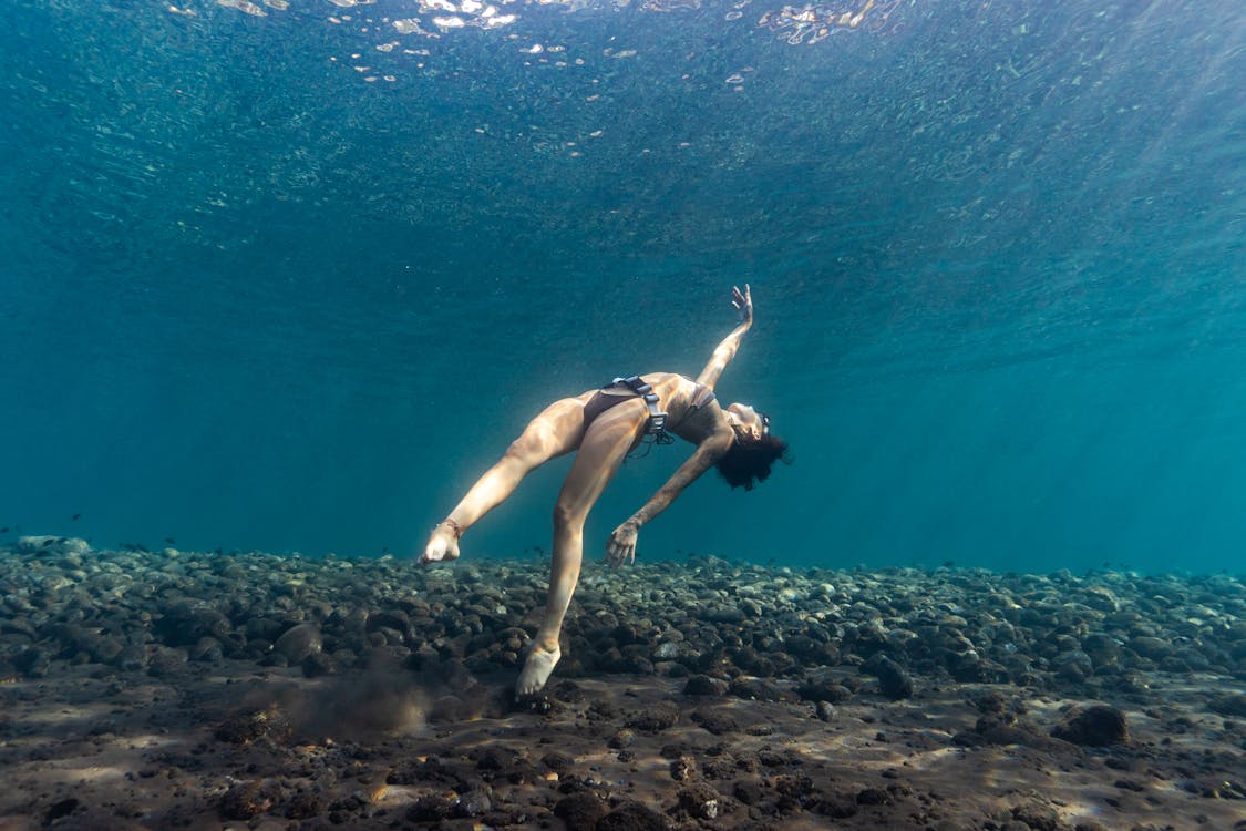 A woman diving under a water 