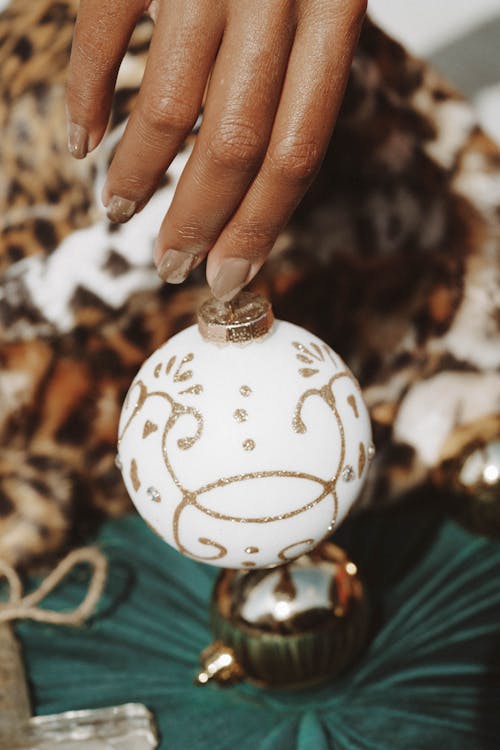 A Close-up Shot of a Person Holding a Christmas Bauble