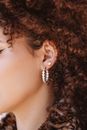 Woman With Brown Hair Wearing Silver and Black Earrings