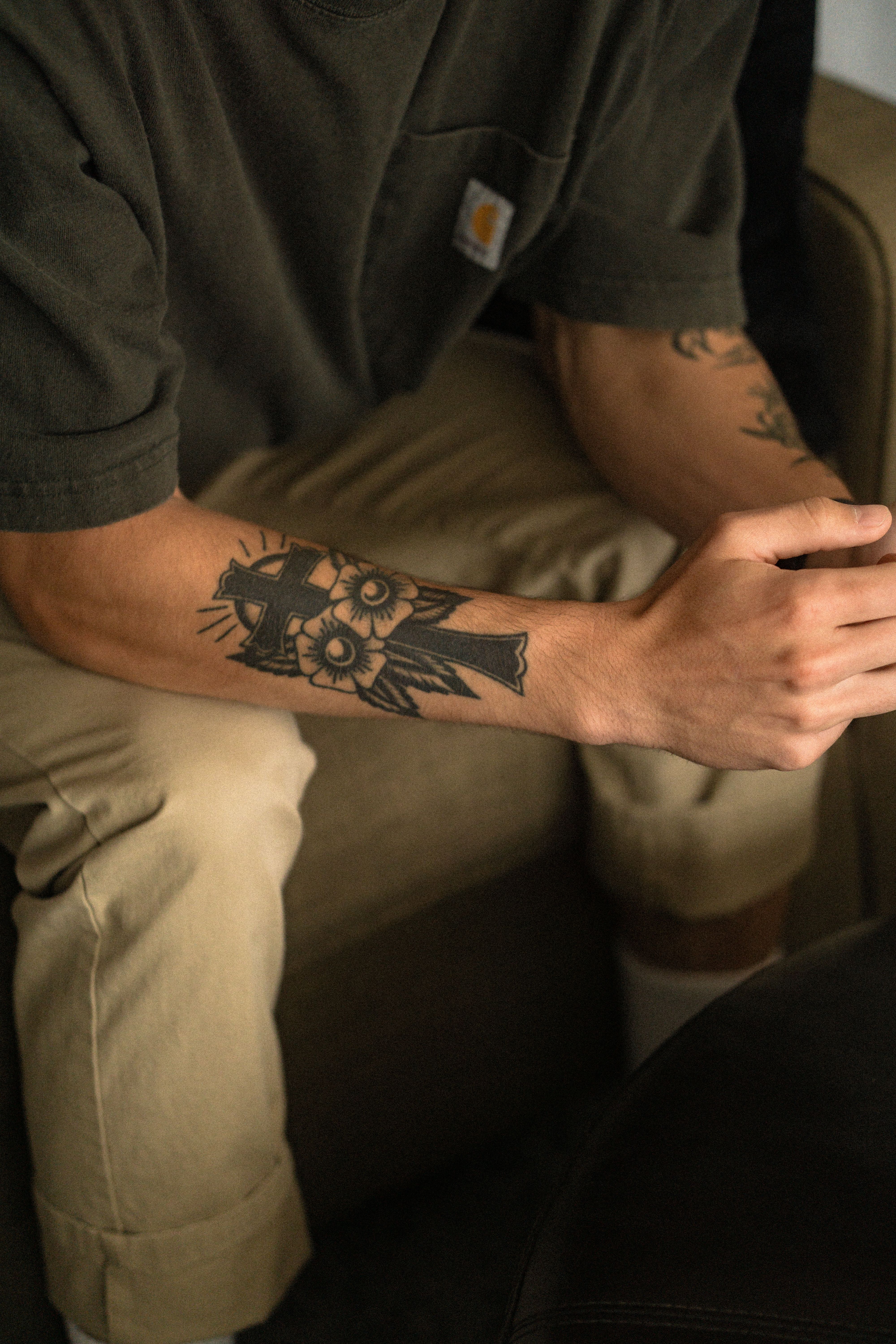 Realistic dog portrait tattoo on a forearm