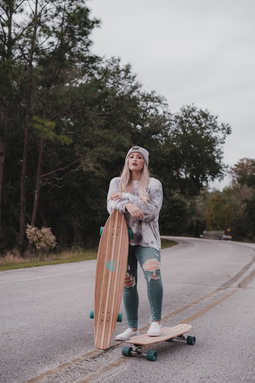 Free Woman Holding a Longboard  Stock Photo
