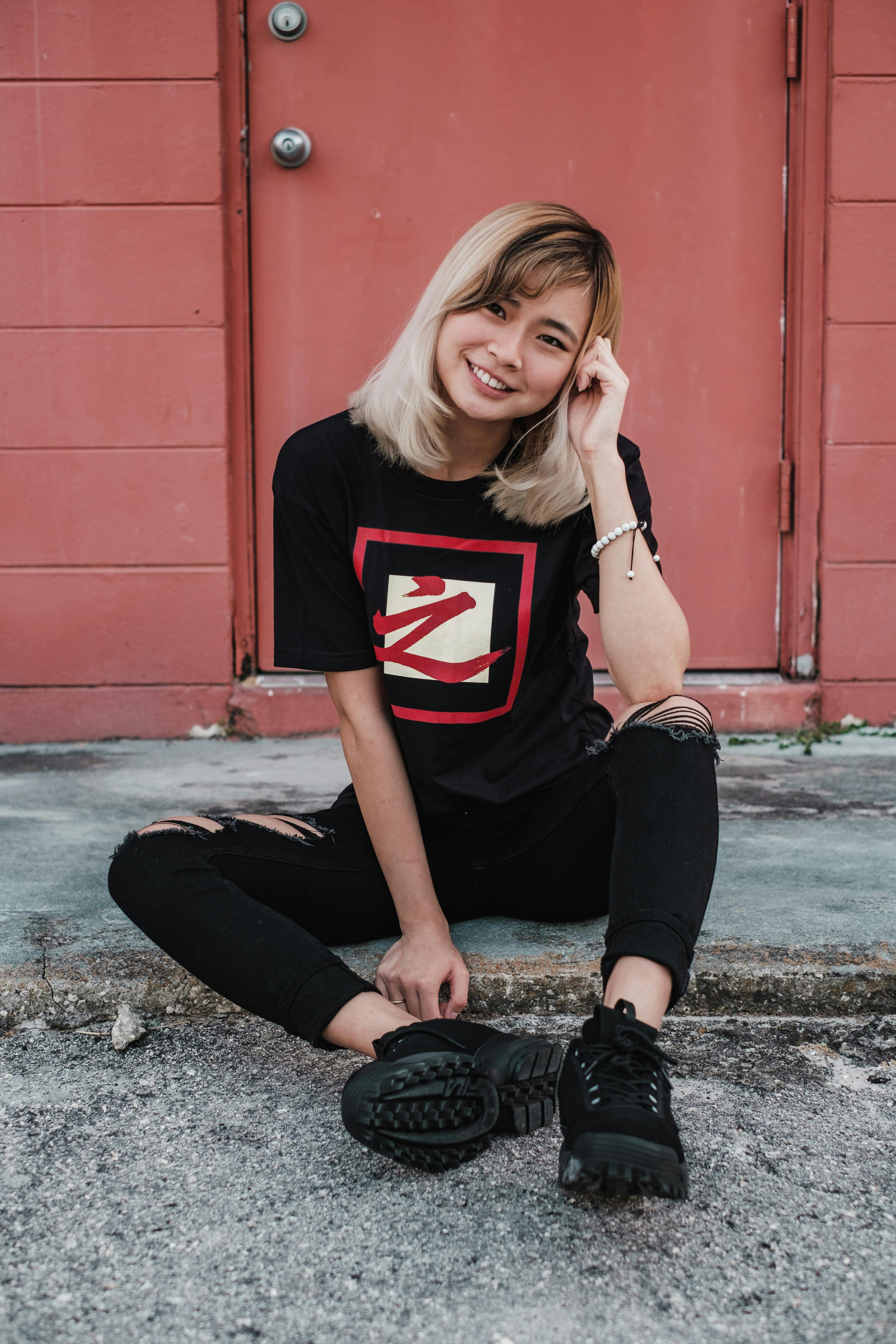 woman sitting on ground smiling at camera