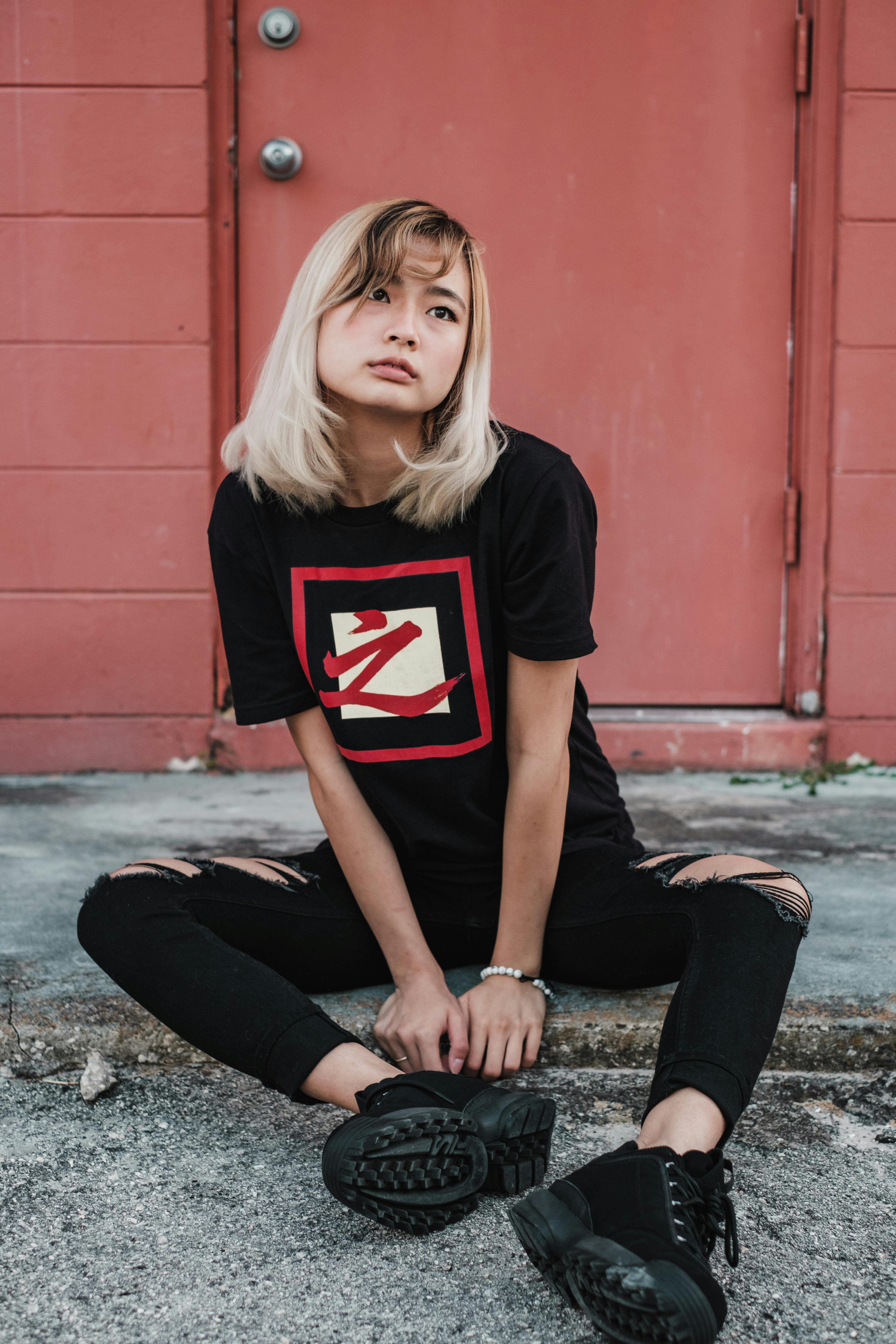 woman sitting on ground looking away