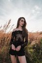 Woman in Black Long Sleeve Shirt Standing on Brown Grass Field