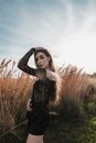 A Woman in a Black Off-Shoulder Sheer Top on a Field