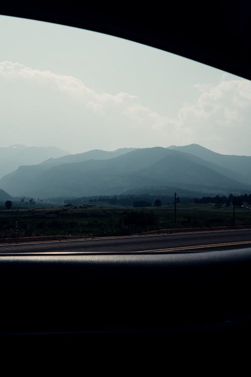 A View of a Mountain Range from inside a Car