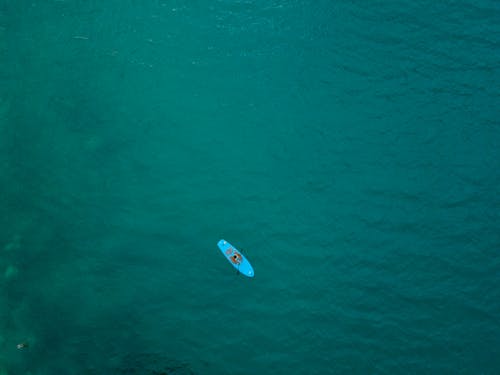 Aerial View of a Person Paddle Boarding