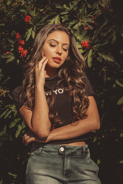 Woman in Black Crop Top and Blue Denim Jeans