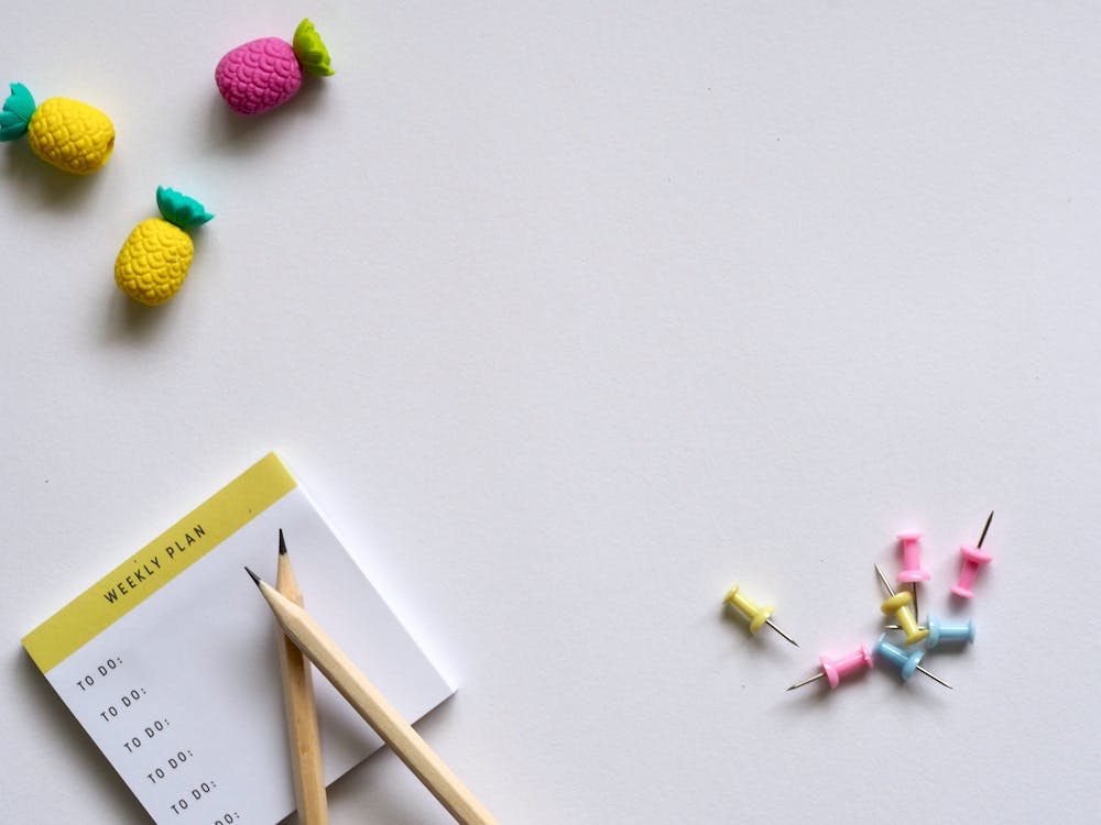 Free Pink, Yellow, and Blue Push Pins and Brown Pencil Stock Photo