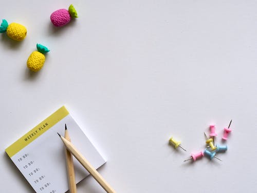 Free Pink, Yellow, and Blue Push Pins and Brown Pencil Stock Photo