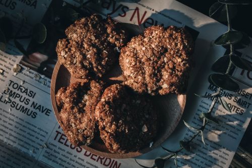Free Delicious freshly baked oatmeal cookies on a wooden plate with a natural arrangement. Stock Photo