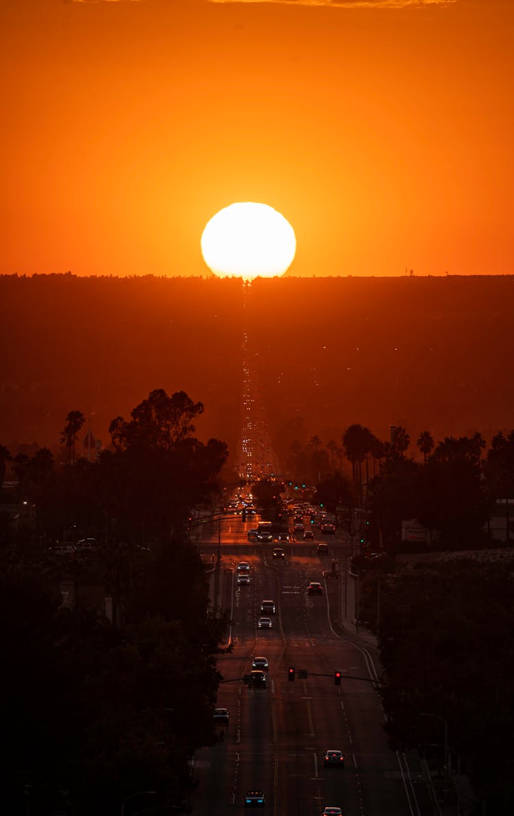 A Drone Shot Of Cars On The Road During Sunset