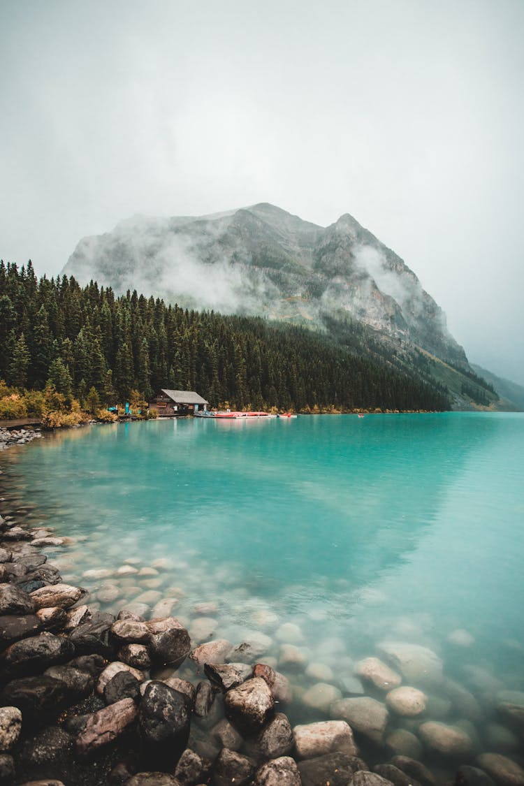 A Long Distance View At A House Near A Mountain Lake 