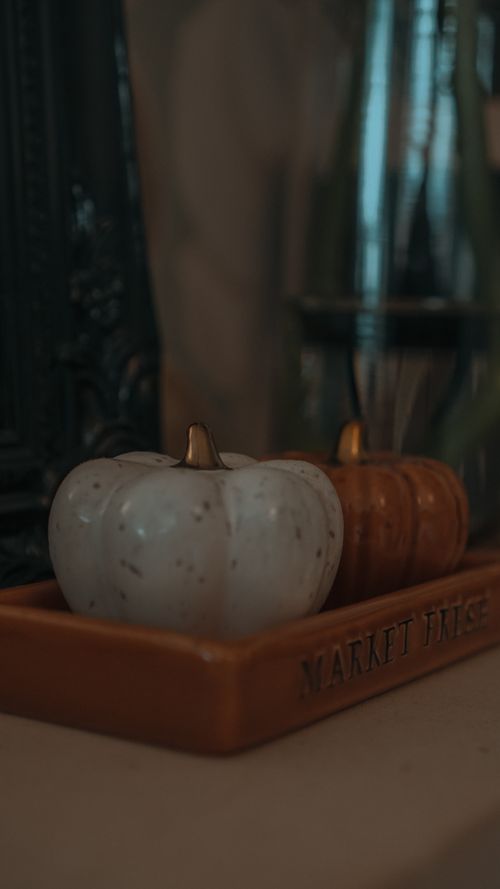 Free Close-up of ceramic pumpkins placed on a decorative tray indoors, evoking autumn vibes. Stock Photo