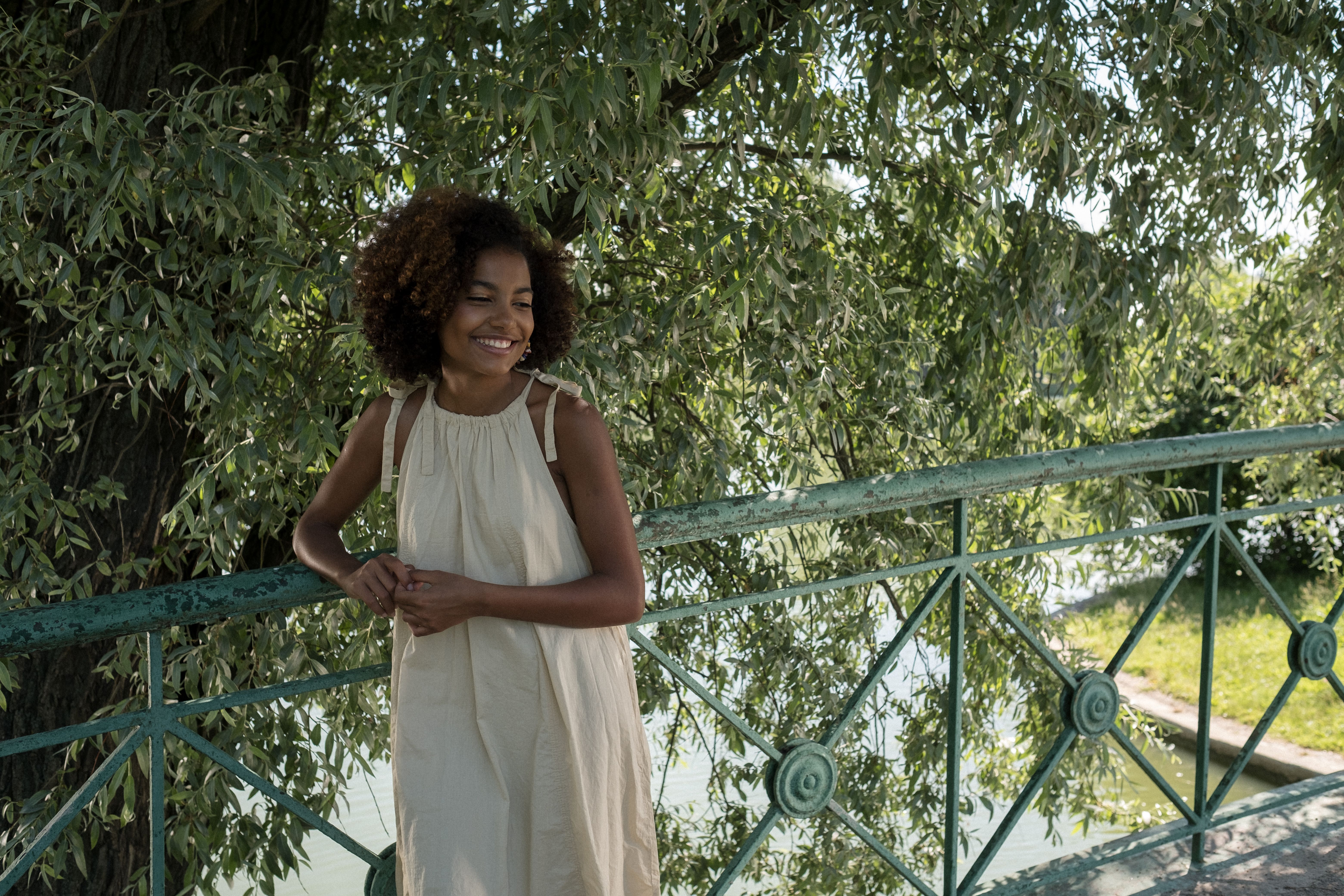 Smiling girl standing on bridge · Free Stock Photo