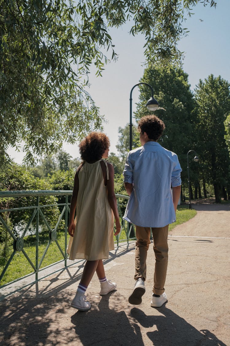 A Couple Walking In A Park