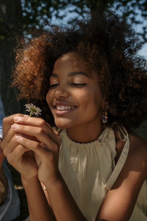 Teenage girl holding flower