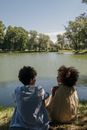A Young Couple Sitting on a Lakeshore