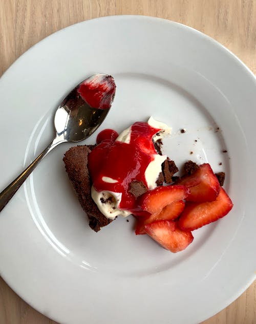 Sliced Strawberries and a Chocolate Cake on a Plate