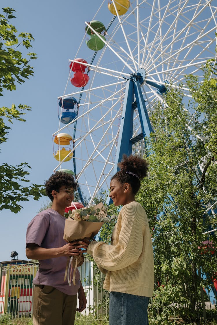 A Man Giving A Flower To A Woman