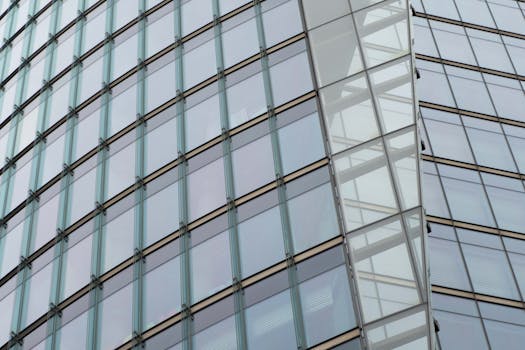 Close-up of a modern building facade with sleek glass panels and architectural design.