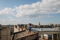 Teenage girl standing on rooftop in city