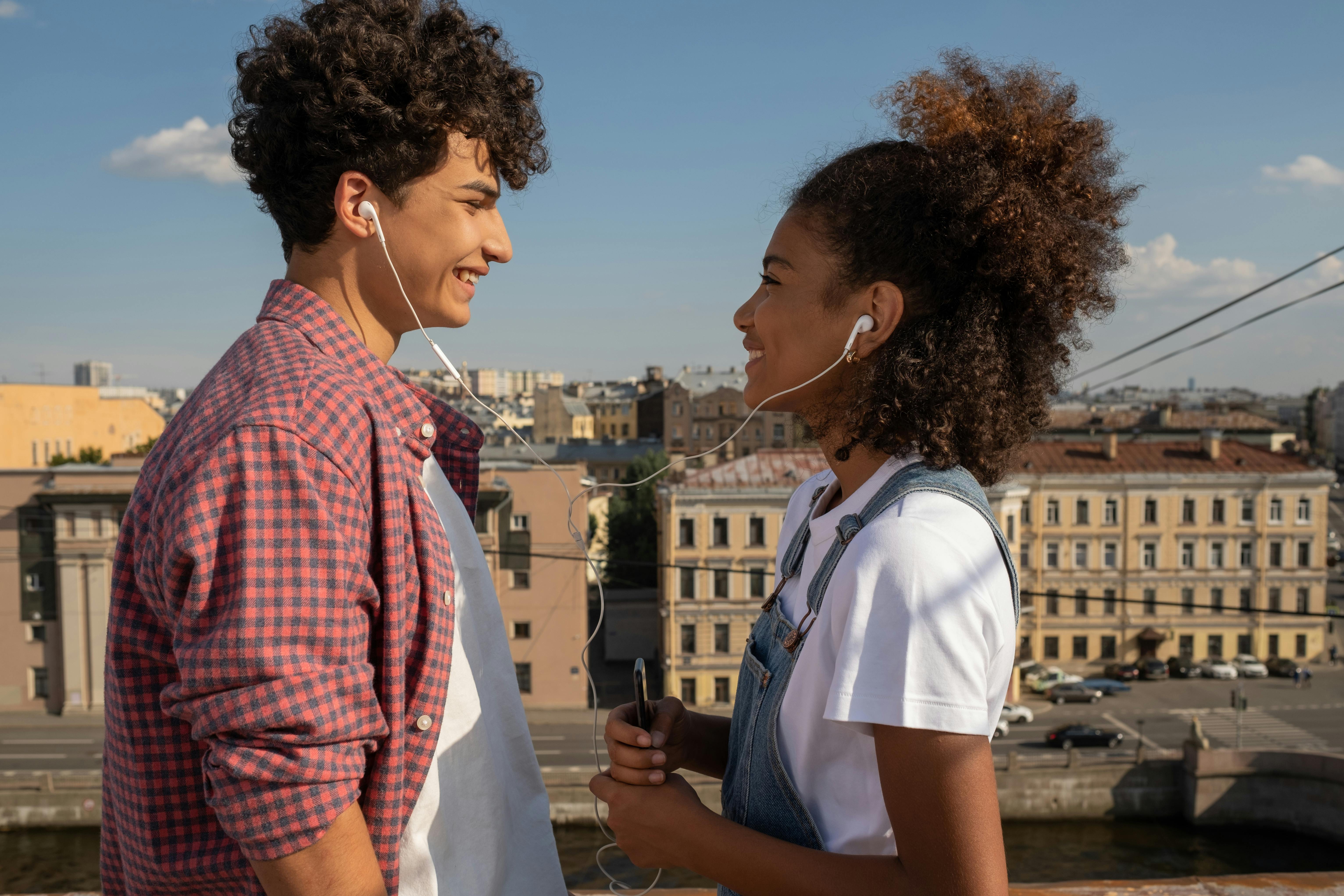 young couple sharing earphones