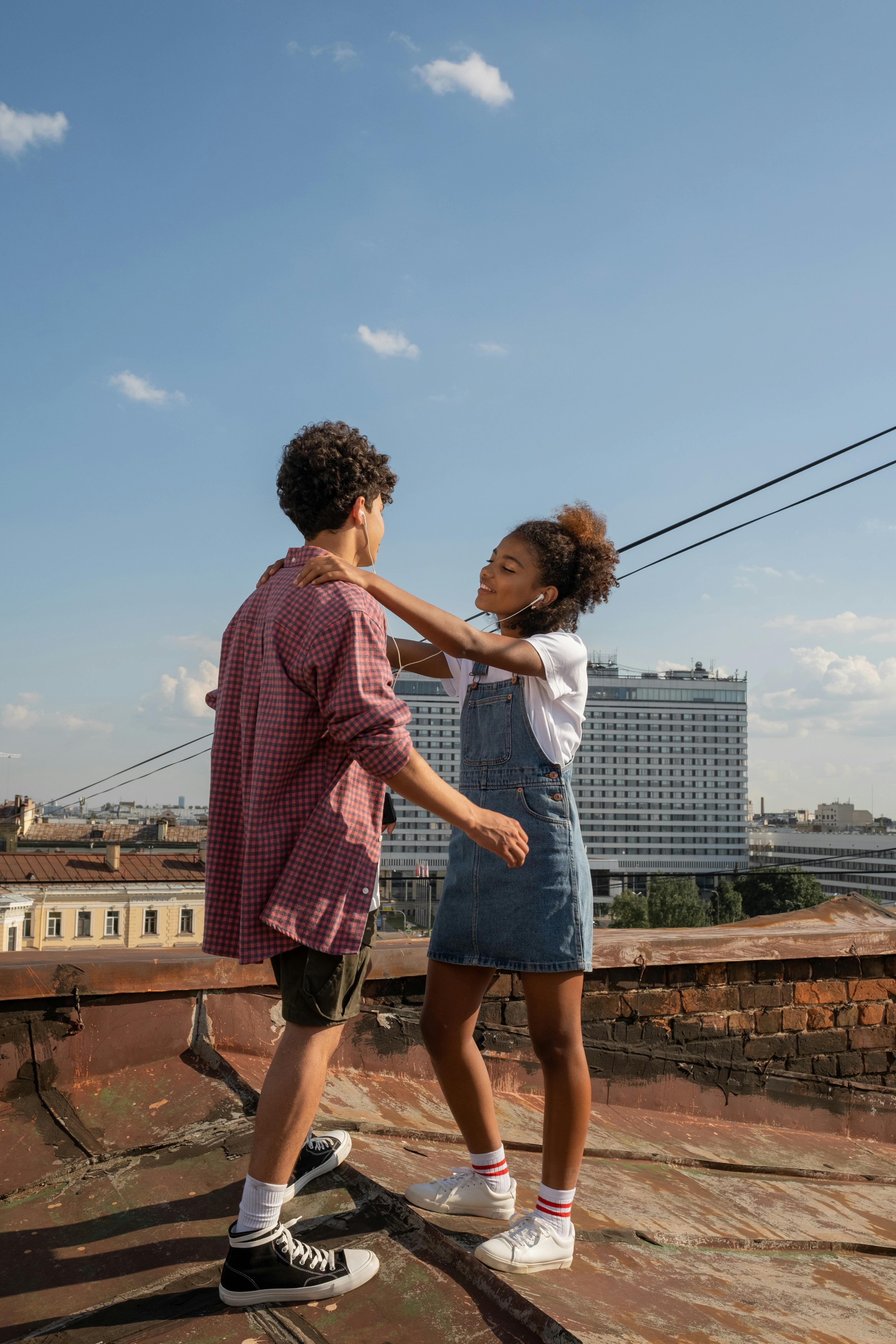 a couple dancing together while standing on the roof