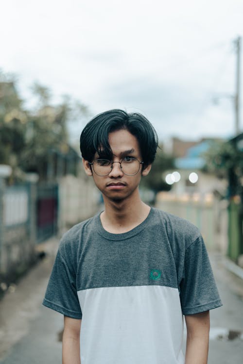 A Portrait of a Man Wearing Eyeglasses