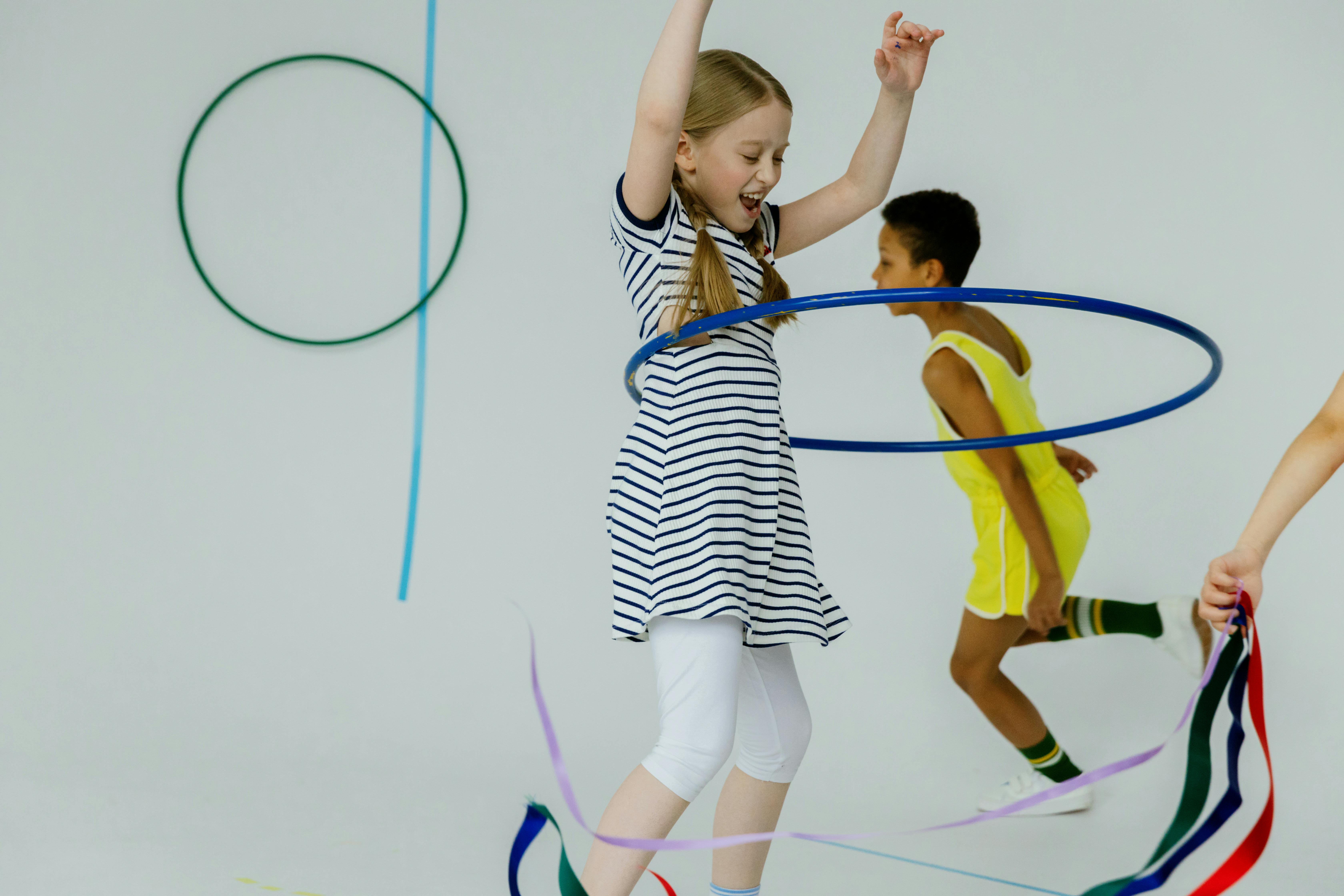 a young girl playing hula hoop