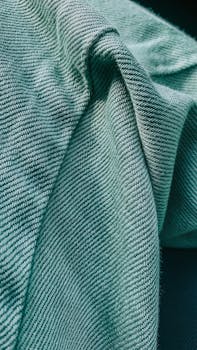 Detailed view of green textured fabric showcasing its woven pattern.