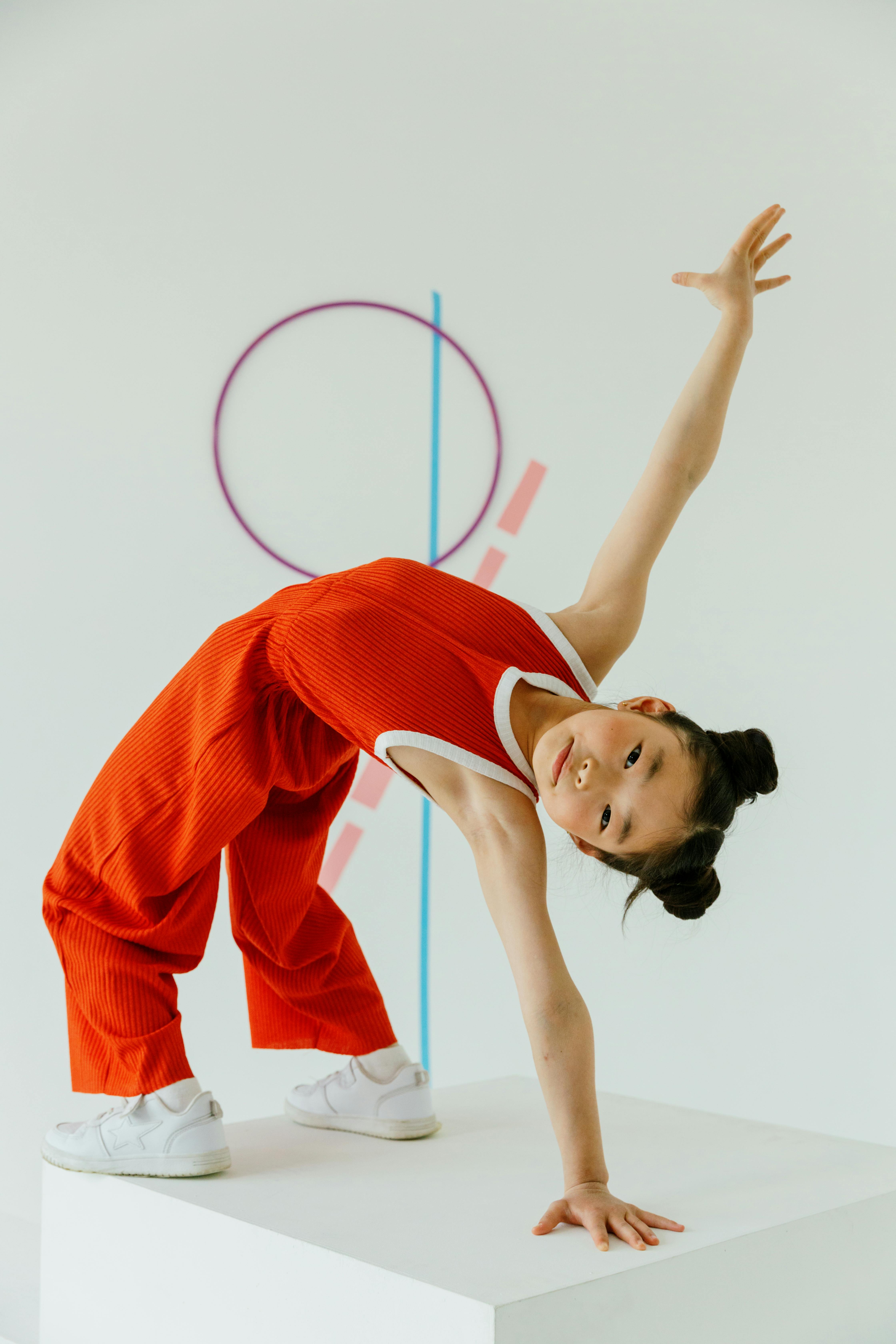 a girl in red clothes leaning backward