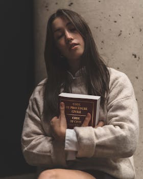 Portrait of a woman holding a legal book, embracing calm and contemplation.