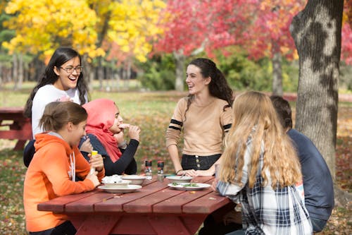 Free People Sitting at the Table in the Park Stock Photo