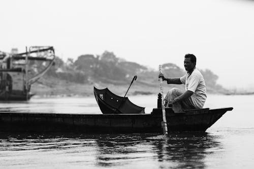 Free A Man Paddling on a Boat Stock Photo