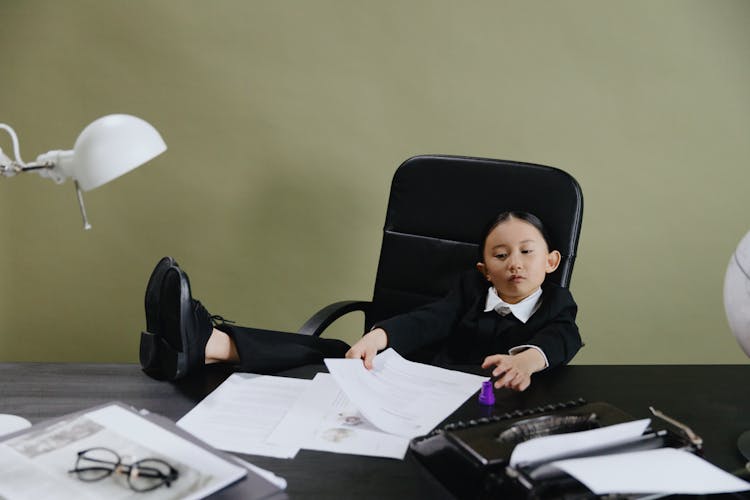 A Young Girl Sitting In The Office