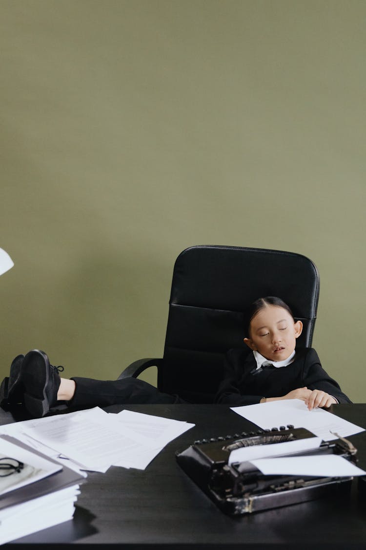 Little Girl Sleeping On Office Chair 