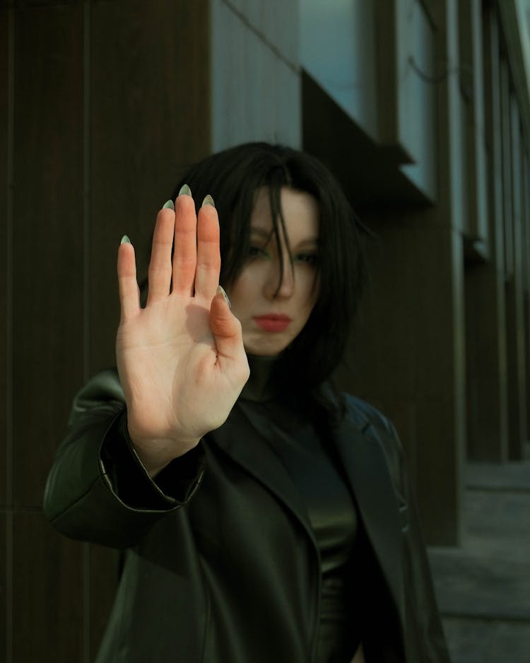 Photo Of A Woman Gesturing Stop With Her Hand