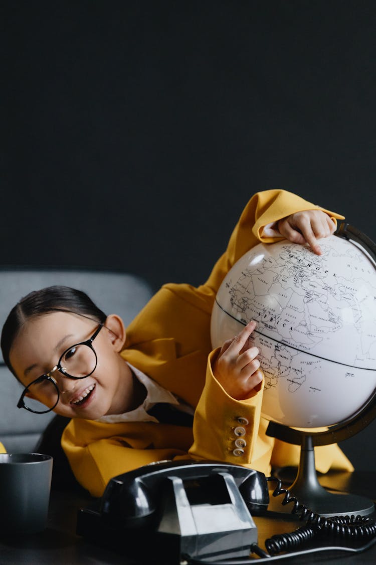 A Girl Holding A Globe