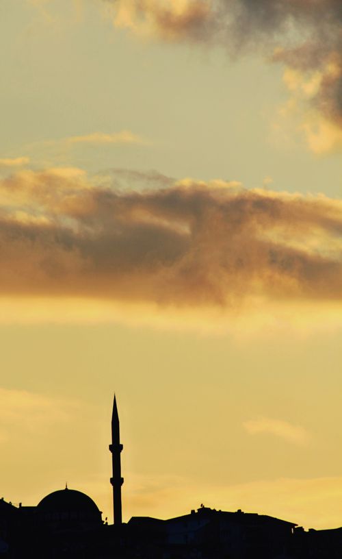 Free A mesmerizing silhouette of a minaret set against a dramatic sunset sky with vibrant clouds. Stock Photo