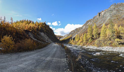 Gravel Road Through Mountains in Autumn 