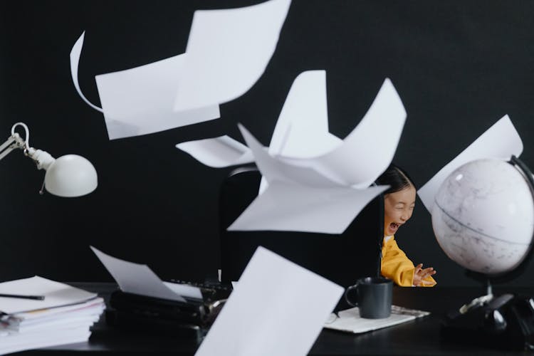 Asian Girl Shouting With Flying Papers Around