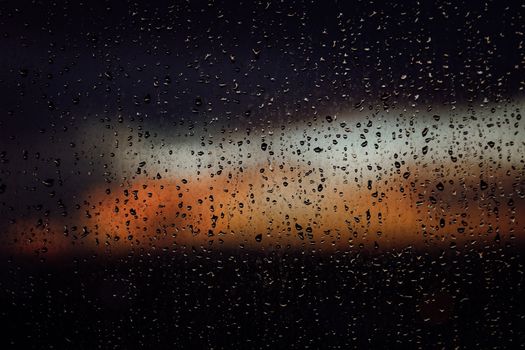 Raindrops on a window create a dramatic view of a colorful sunset in Fort Lauderdale, Florida.