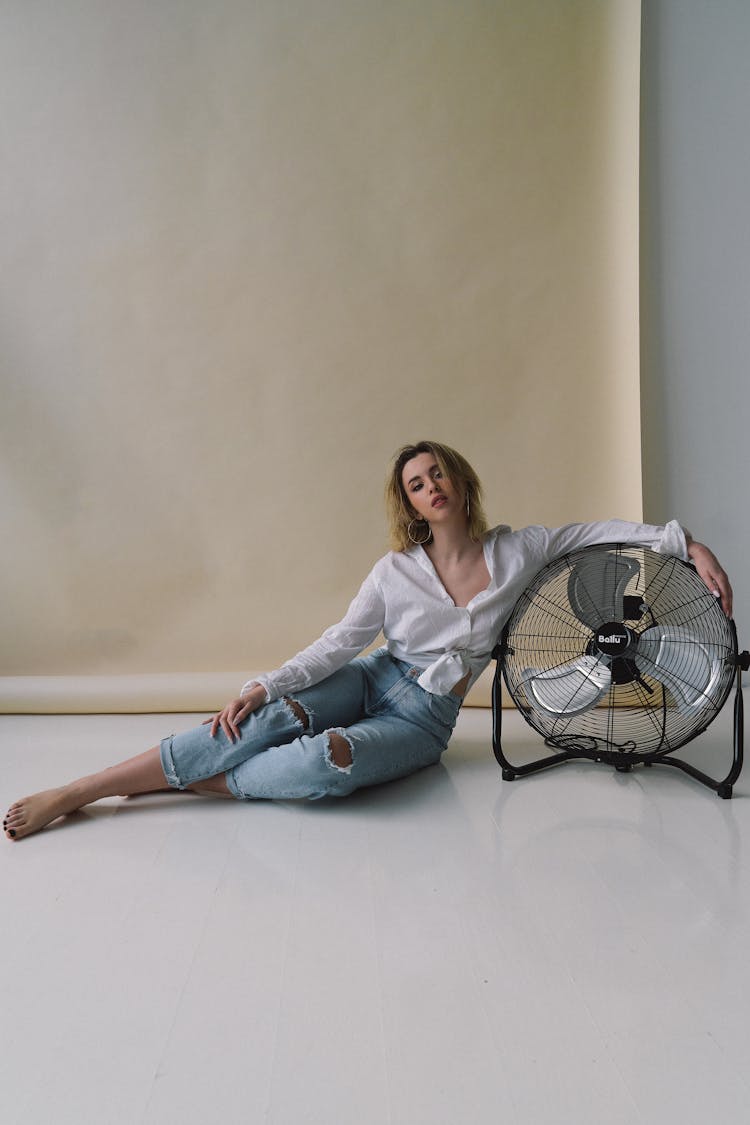 Studio Portrait Of Woman With Fan