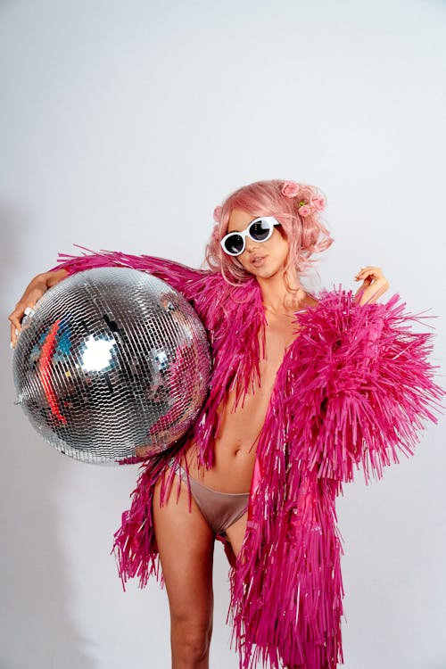 Free Portrait of woman holding disco ball Stock Photo
