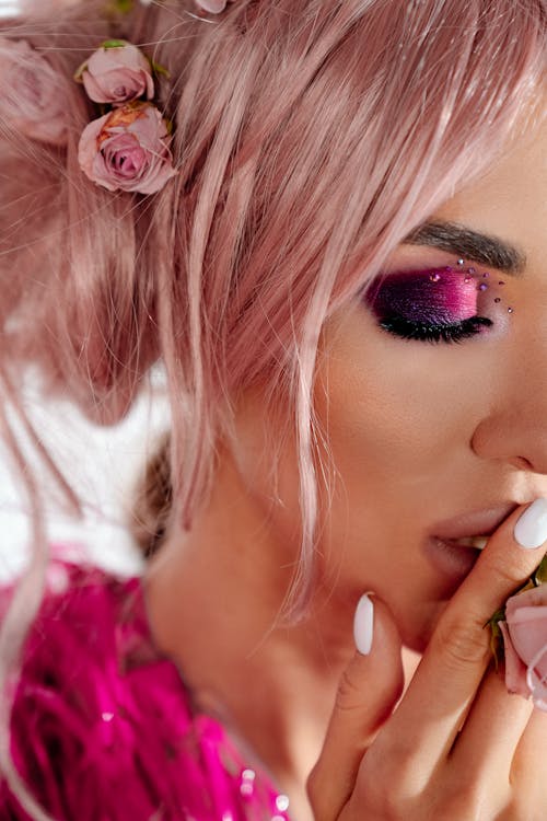 Face of woman with pink hair and make-up