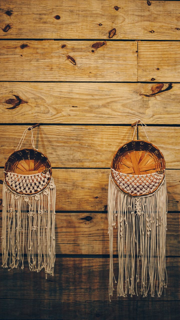 Large natural fiber woven wall hanging displayed behind a boho coffee bar counter with accessories